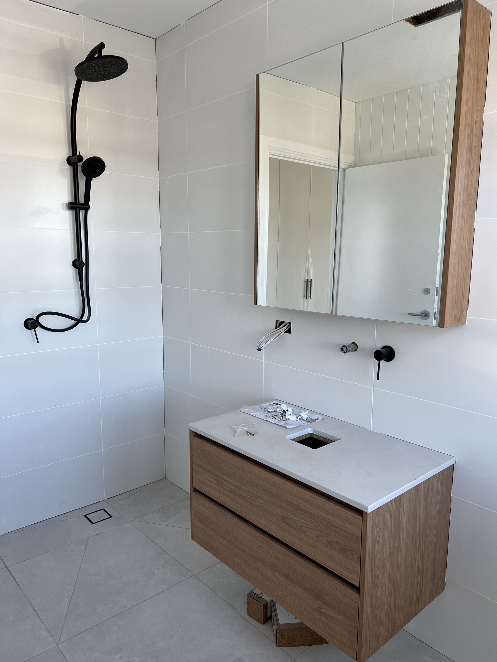 Bathroom shower and vanity installation with fresh white finishes