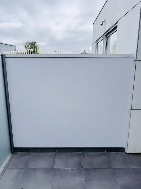 Exterior rendered wall with dark trim