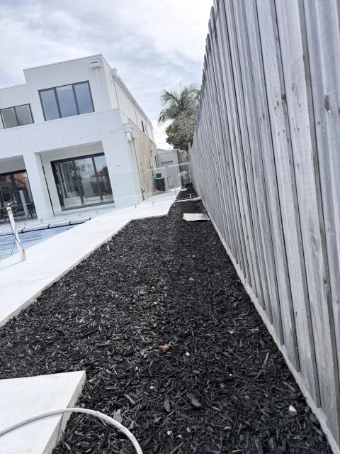 Timber boundary fence beside a house