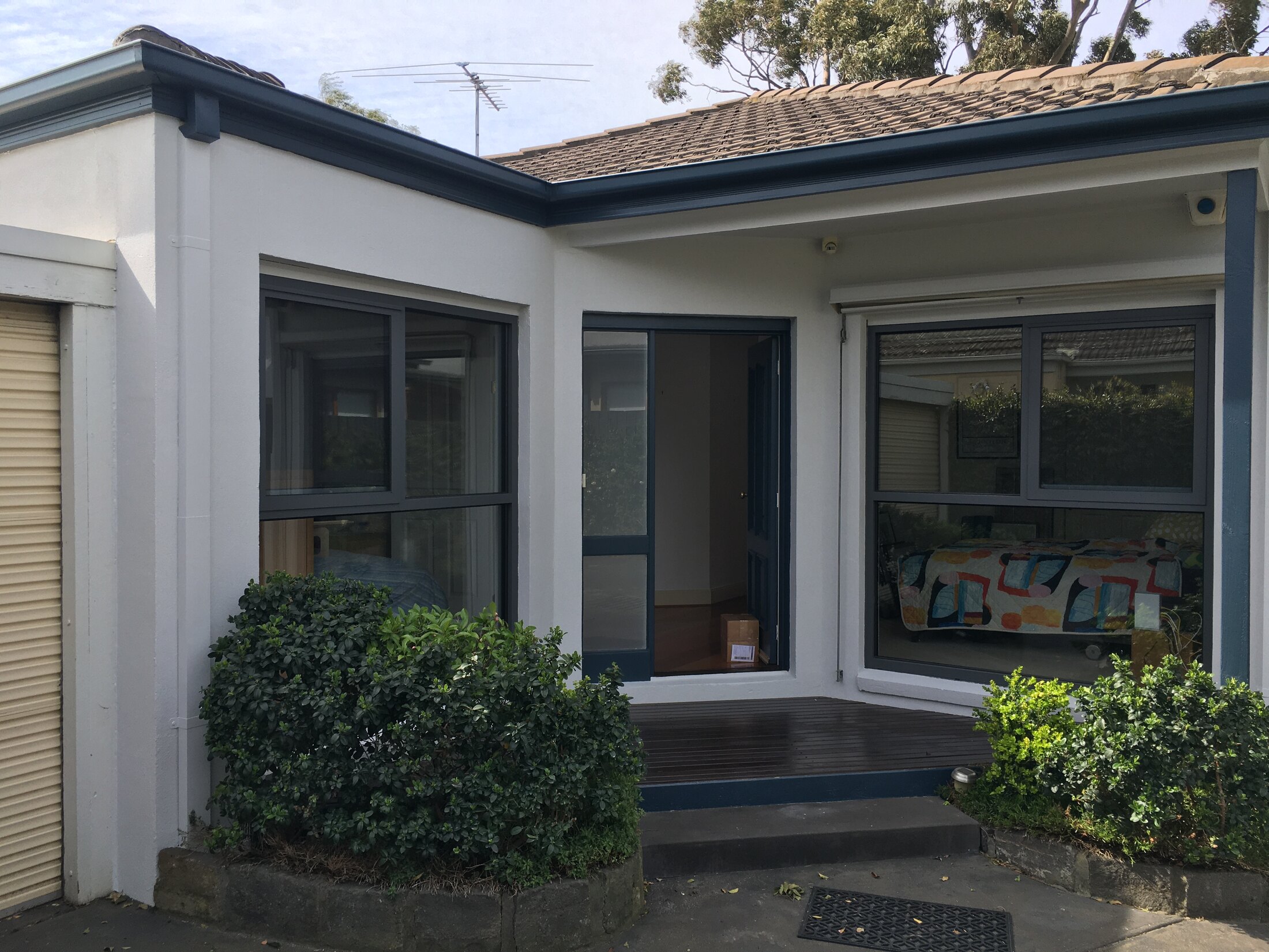 Fresh white front fence repaint improving street presentation