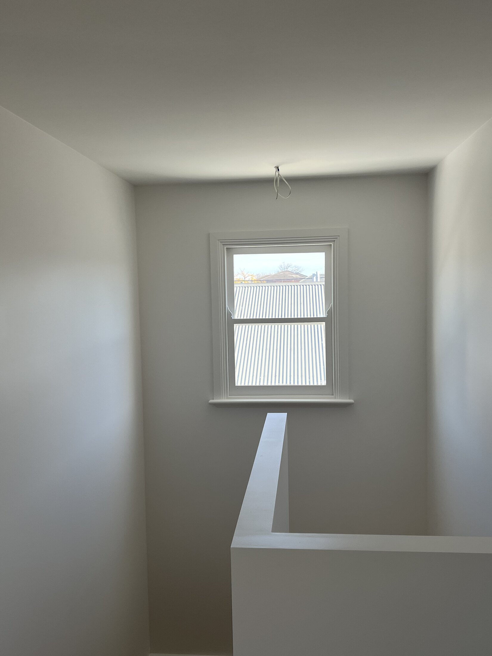 Hallway repaint with window trim and bright interior finish